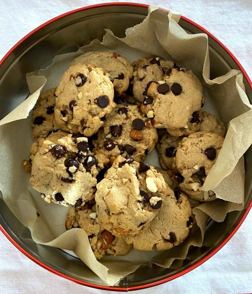 a tin of chocolate chip cookies with chocolate chips and nuts