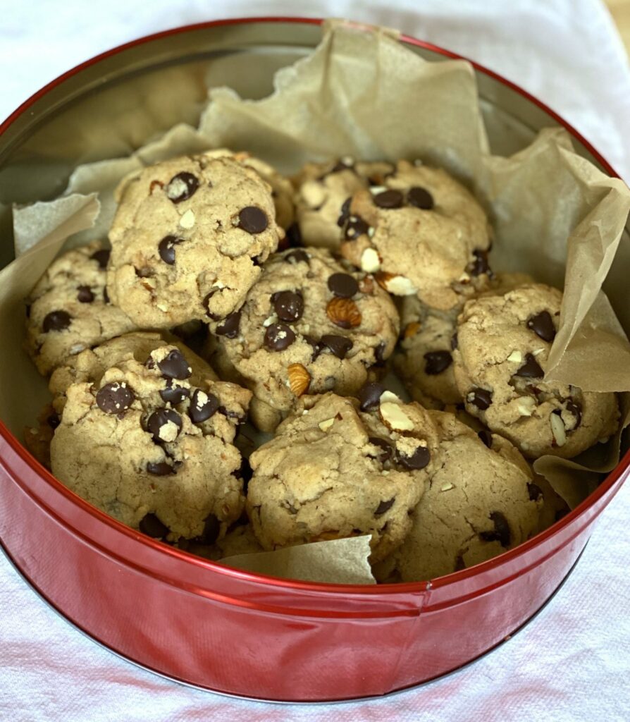a tin of chocolate chip cookies with chocolate chips and nuts