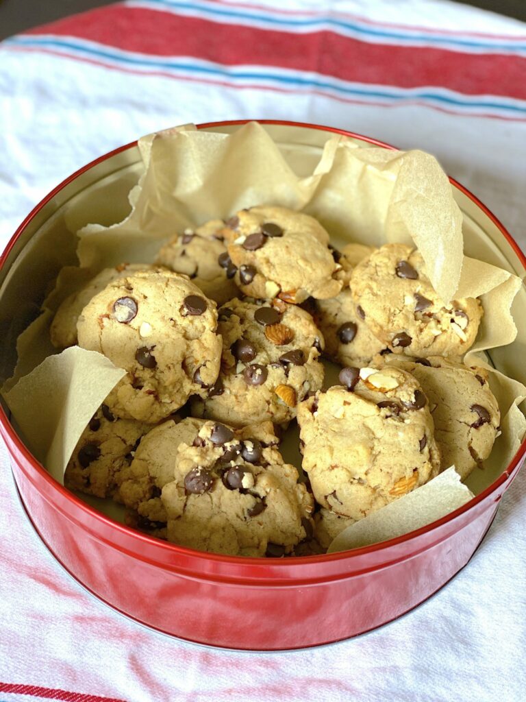 a tin of chocolate chip cookies with nuts